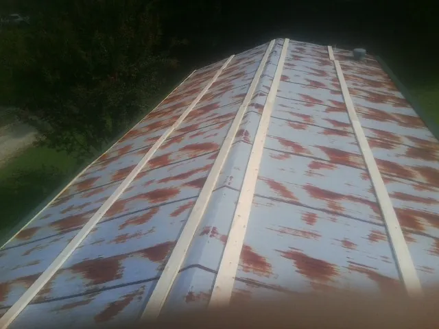 Rusted metal roof panels with new wood purlins before replacement — Storm Damage Roof Repair in Dorothy by Roofing Brothers