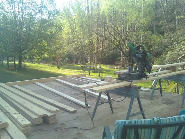 Miter saw and framing lumber on a deck under construction in Dorothy